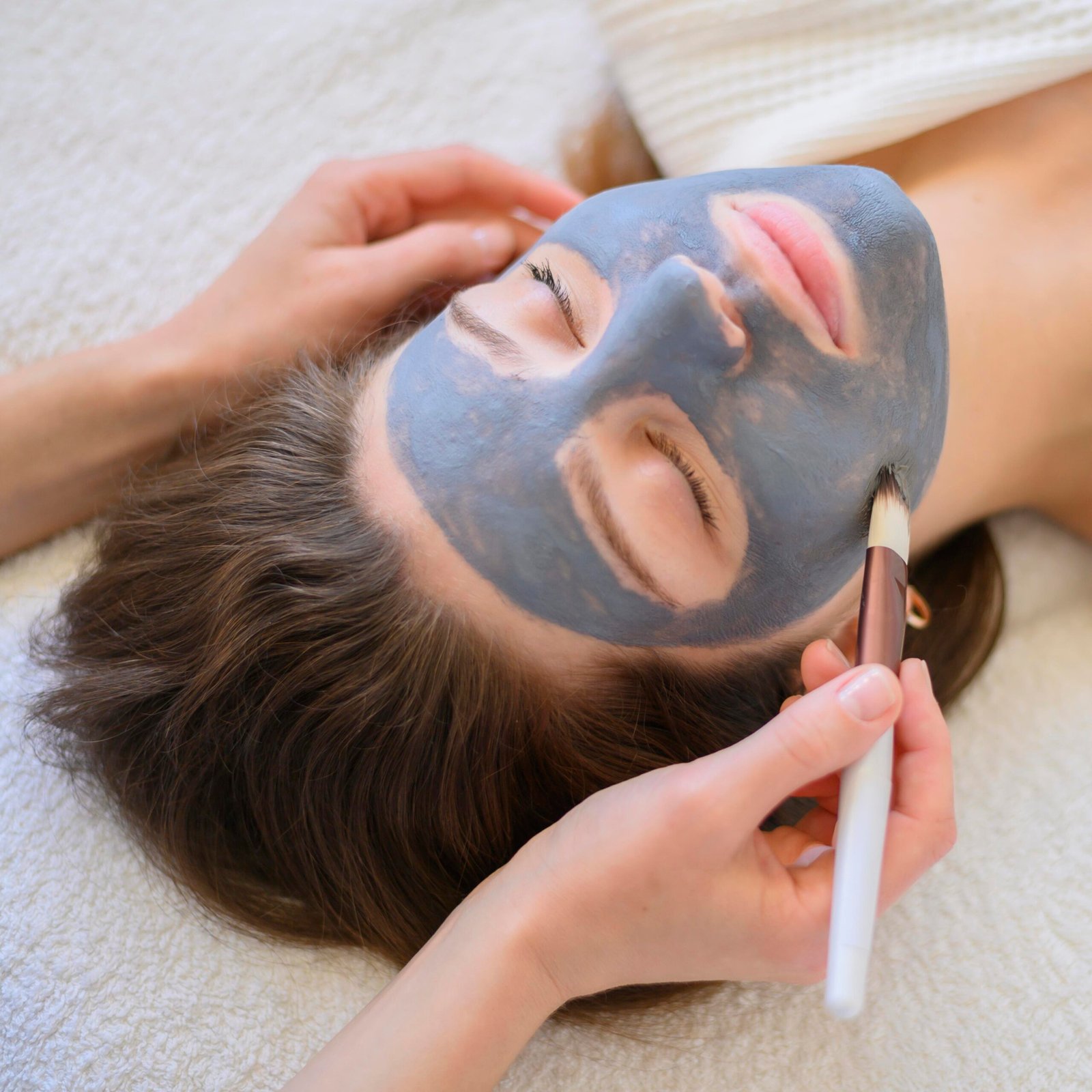 high angle woman getting face mask scaled